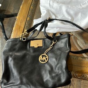 Michael Kors’s black leather bag with  gold chain detail